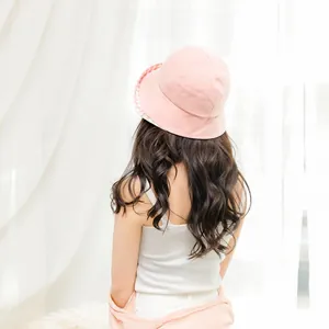 Detail view of pink sun bucket hat with gingham lining under the brim for women