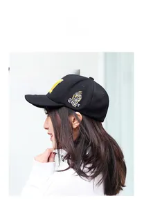 Detail of tiger head embroidery and calligraphy on black cotton baseball cap side