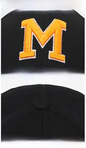 Detail of premium orange M letter embroidery and stitched crown on black baseball cap