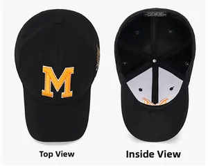 Detail view of black baseball cap with orange M embroidery and inner lining with label