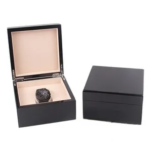 Detail of premium black piano lacquer wood watch storage box with soft interior lining