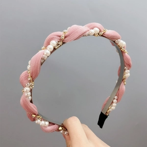 Detail of pink twisted headband with white pearls and sparkling crystal embellishments