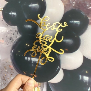 Detailed view of Best Day Ever gold mirror acrylic cake topper held by hand for birthdays
