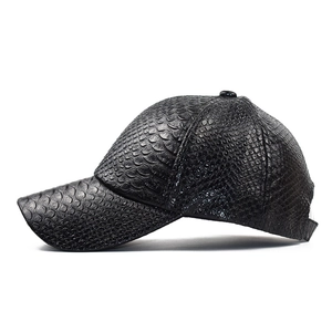 Detail shot of the black faux crocodile embossed PU leather texture on a baseball cap
