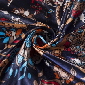 Macro detail of 90cm silk-like scarf with ethnic elephant and floral pattern