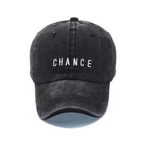 Detailed view of white CHANCE letter embroidery on vintage washed cotton baseball cap