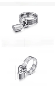 Detail view of 6mm stainless steel band with zircon inlay and padlock charm pendant