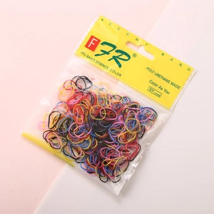 Macro shot of colorful TPU elastic hair bands in transparent packaging with yellow header card