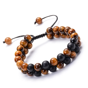 Detailed view of 8mm tiger eye and matte obsidian double-row woven bracelet on white background
