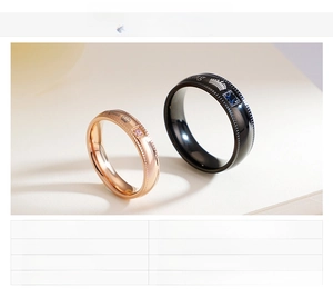 Detailed macro view of brushed stainless steel couple rings with crown and king engravings