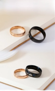 Detail of crown rings for couples with square zircon stones and King engraving