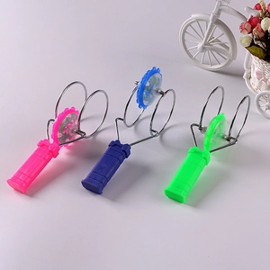 Detail view of colorful magnetic spinning gyro toys with LED lights in pink, blue, and green