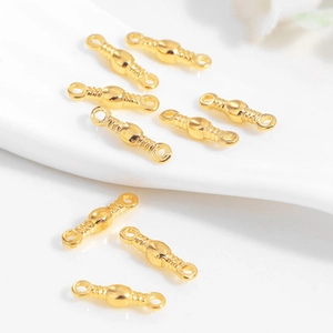 Macro shot of gold-plated cylindrical connector links for DIY jewelry making