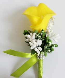 Detail of yellow calla lily boutonniere with lime green ribbon and rhinestone accents