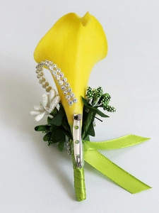 Detail of yellow calla lily boutonniere with silver rhinestones and green ribbon