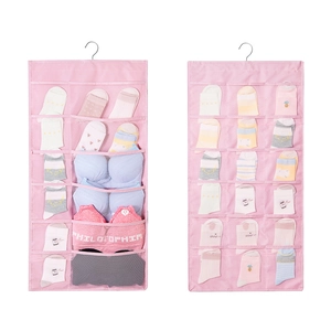 Detail of pink oxford fabric hanging organizer with mesh pockets and metal hooks