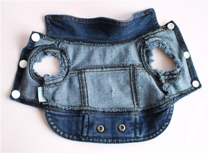 Detailed view of the dark blue denim dog vest showing white snaps and raw edge hem