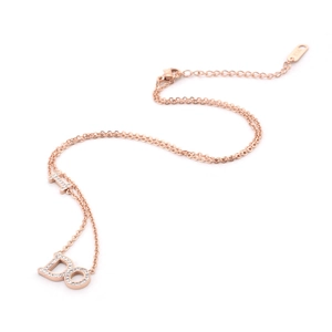 Detail of rose gold necklace with 14K stamp and zircon-encrusted Do letter pendant