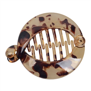 Close-up of a tortoiseshell resin banana hair clip with leopard pattern and interlocking teeth