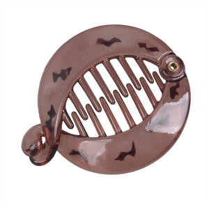 Close-up of translucent brown banana hair clip with interlocking teeth and patent logo