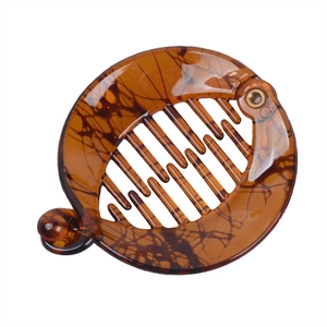 Close-up of tortoise shell banana hair clip with rounded design and sturdy inner teeth