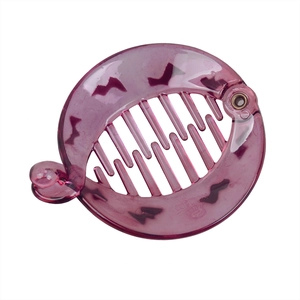 Detail of translucent purple banana hair clip with black bat pattern and metal hinges