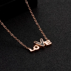 Minimalist rose gold LOVE necklace with black enamel detail on a delicate O-chain