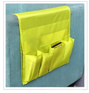 Detail of neon green sofa armrest organizer with pockets for phone and remote