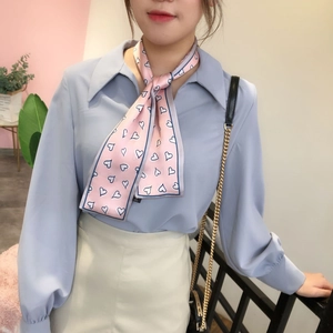 Pink heart print skinny silk scarf tied as a fashion necktie accessory for women