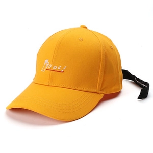 Detail of yellow washed cotton baseball cap featuring unique long black back strap and embroidery
