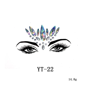 Detailed macro view of iridescent acrylic face jewels in a crown layout for festivals