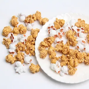Macro detail of realistic resin popcorn charms in buttery yellow and white shapes