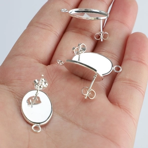 Three silver-plated teardrop earring base posts with loops for DIY jewelry making