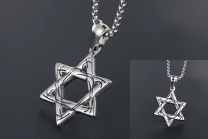 Macro detail of vintage hexagram pendant with engraved runes in polished titanium steel