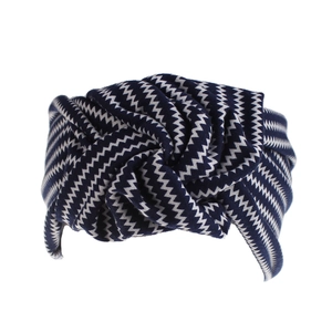 Detail of twisted headband featuring navy blue and white bohemian zigzag knit pattern
