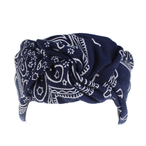 Detail of navy blue paisley twist headband featuring white floral patterns and soft fabric