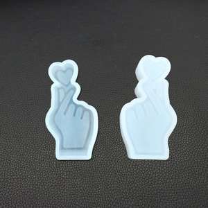 Macro view of two heart hand gesture silicone molds for DIY crystal epoxy resin and plaster
