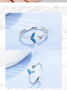 Detail of silver mermaid tail ring with blue finish and sparkling crystal stone