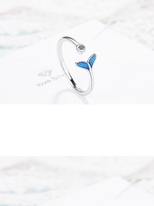 Detail of silver fish tail ring with blue enamel and clear sparkling cubic zirconia