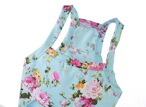 Close-up of neckline stitching on floral cotton pet dress with fine knit texture detail