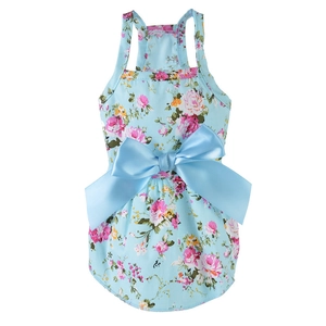 Detail of light blue floral dog dress showing satin bow and intricate fabric texture