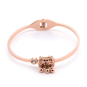 Detail of rose gold bangle with engraved Chinese character peace and round clear stone