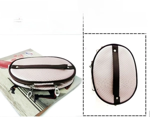 Close-up of pink polka dot cosmetic bag with dual metal zippers and leather handle