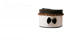 Detailed view of polka dot makeup bag with lace trim, black bow, and dimensions 20x15x13cm
