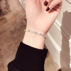 Close-up of a silver tennis bracelet with sparkling zircons worn on a wrist