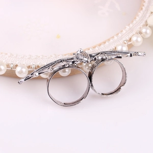 Gothic silver bat open double-finger ring with adjustable wings on a pearl tray
