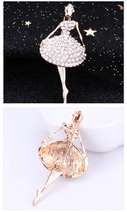 Detail view of a ballet dancer brooch with gold plating and sparkling rhinestones