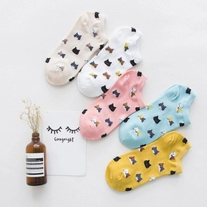 Flat lay of five pairs of Japanese-style cotton cat pattern ankle socks in pastel colors