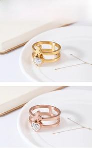 Detail of double-layer steel rings with镂空 figure and zircon heart charms