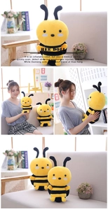 Close-up of cute yellow bee plush dolls in various sizes with soft striped fabric